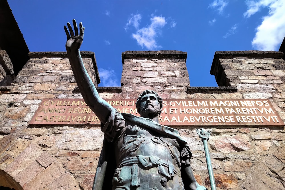 man raising his hand statue