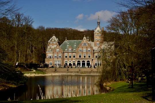 brown and white concrete building near body of water during daytime in Bloemendaal Netherlands