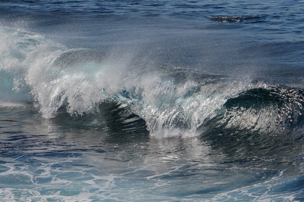 ocean waves crashing on shore during daytime