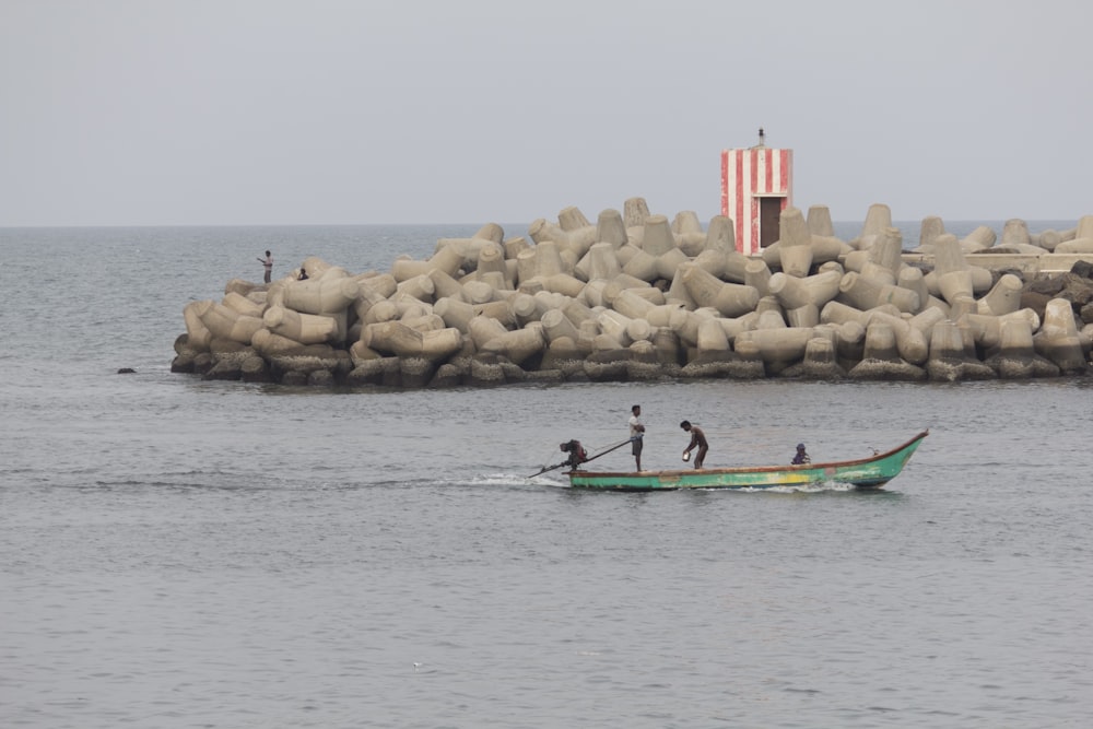 man riding on green kayak on sea during daytime