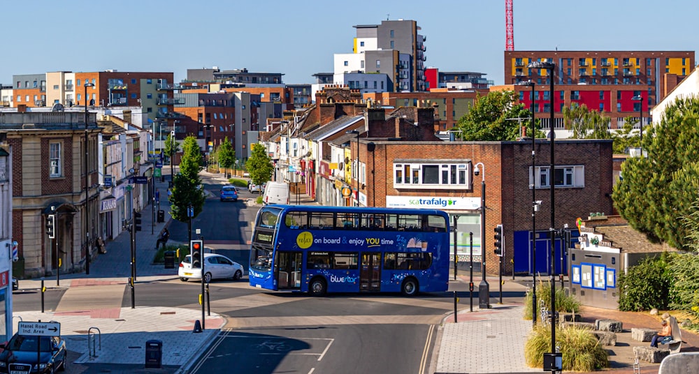 blue bus on road during daytime