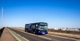 blue and yellow bus on road during daytime