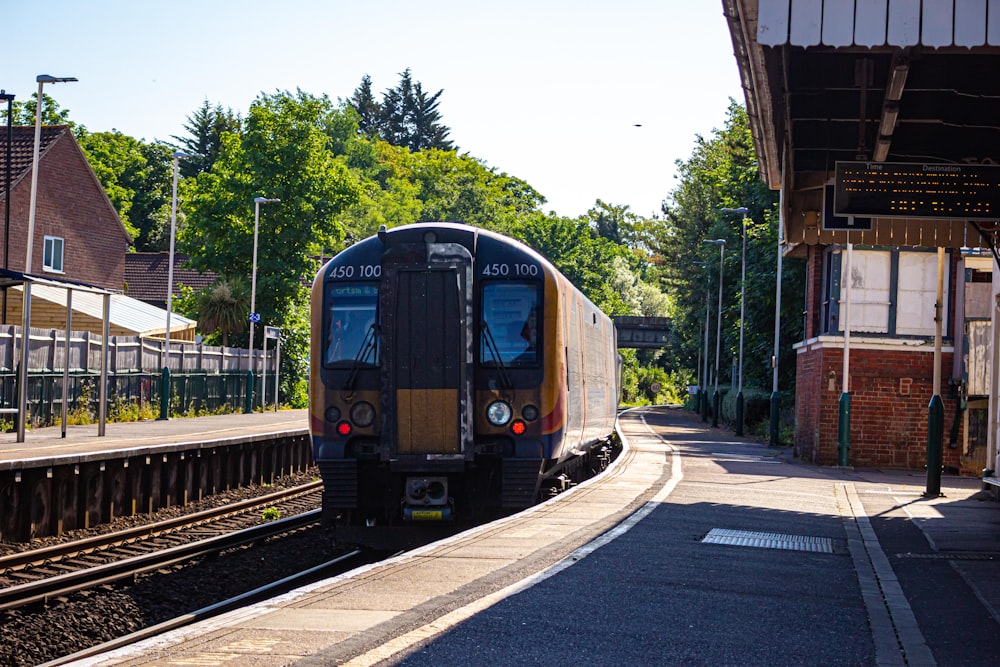 blue and white train on rail road during daytime