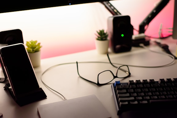 A sleek workspace with futuristic AR glasses and AI interface screens glowing softly.