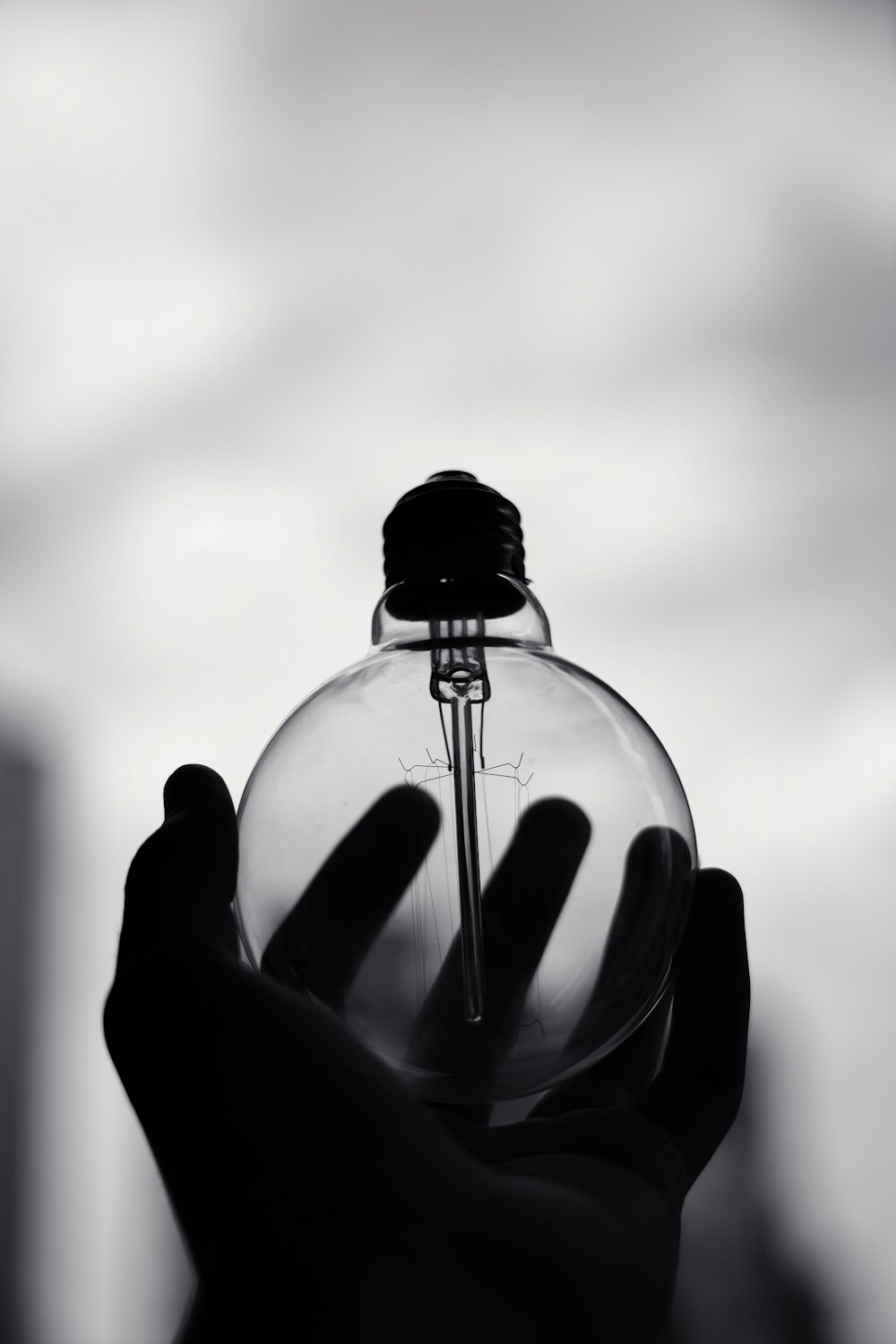 person holding clear glass ball