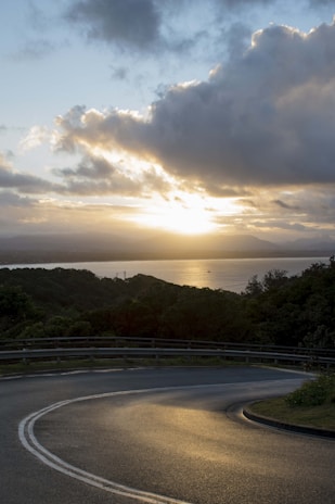 A scenic view of a winding road through lush greenery near Tangalle at sunset.