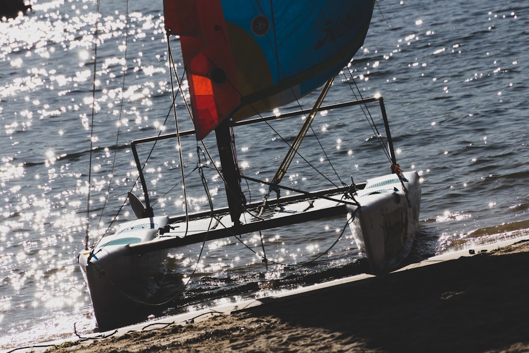 blue red and yellow sail boat on sea during daytime