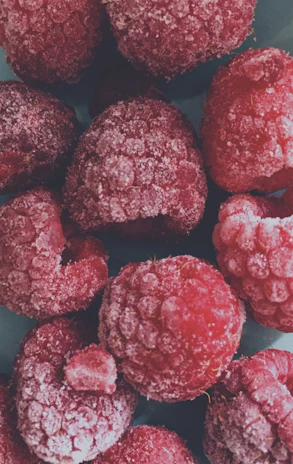 A cinematic shot of freshly harvested frozen fruits glistening under soft golden light.