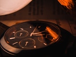 Close-up of the watch's refined dial with warm luster reflecting soft light.