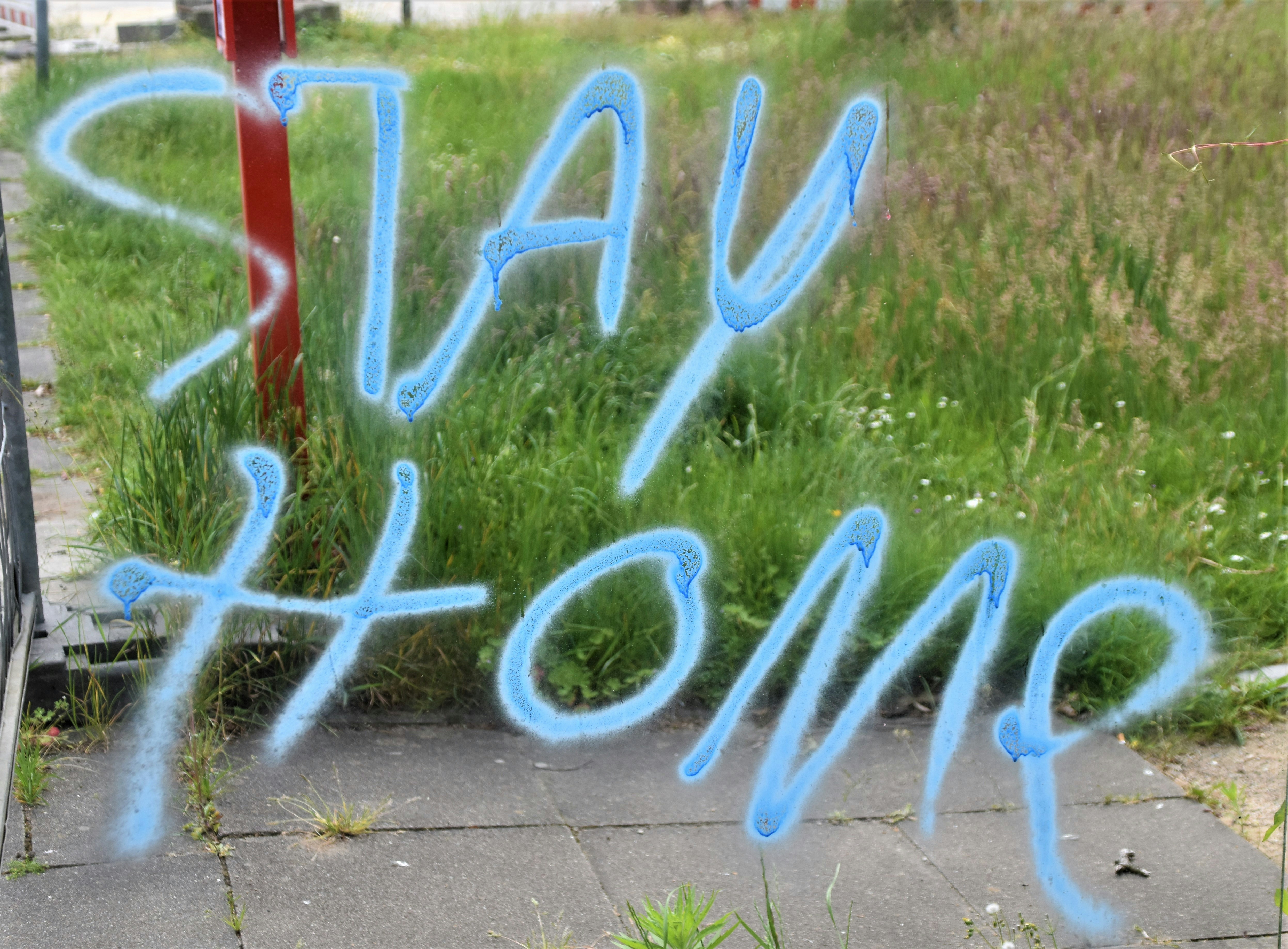 Stay Home, a graffiti on a bus station window during the covid-19 crisis, quarantine