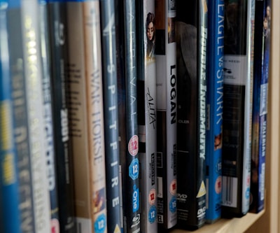 assorted books on white wooden shelf