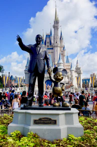 people standing near grey statue during daytime