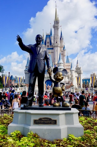 people standing near grey statue during daytime