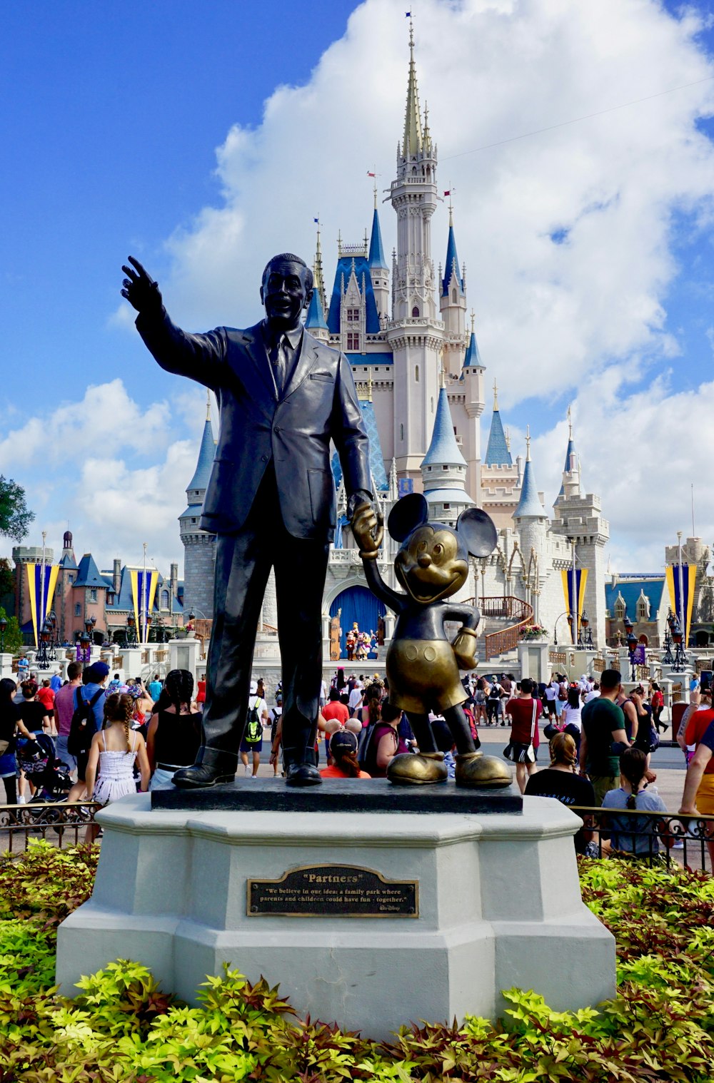 people standing near grey statue during daytime