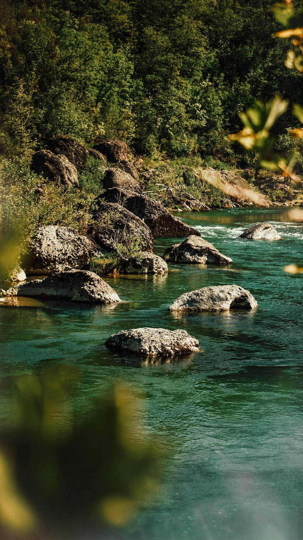 gray rocks on body of water during daytime