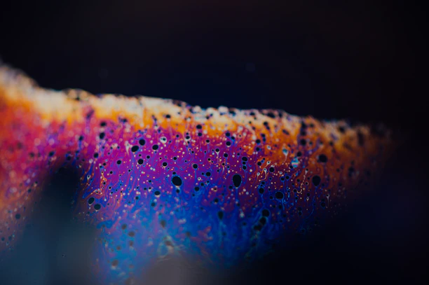 Close-up of a vibrant abstract print, emphasizing rich textures and swirling colors.