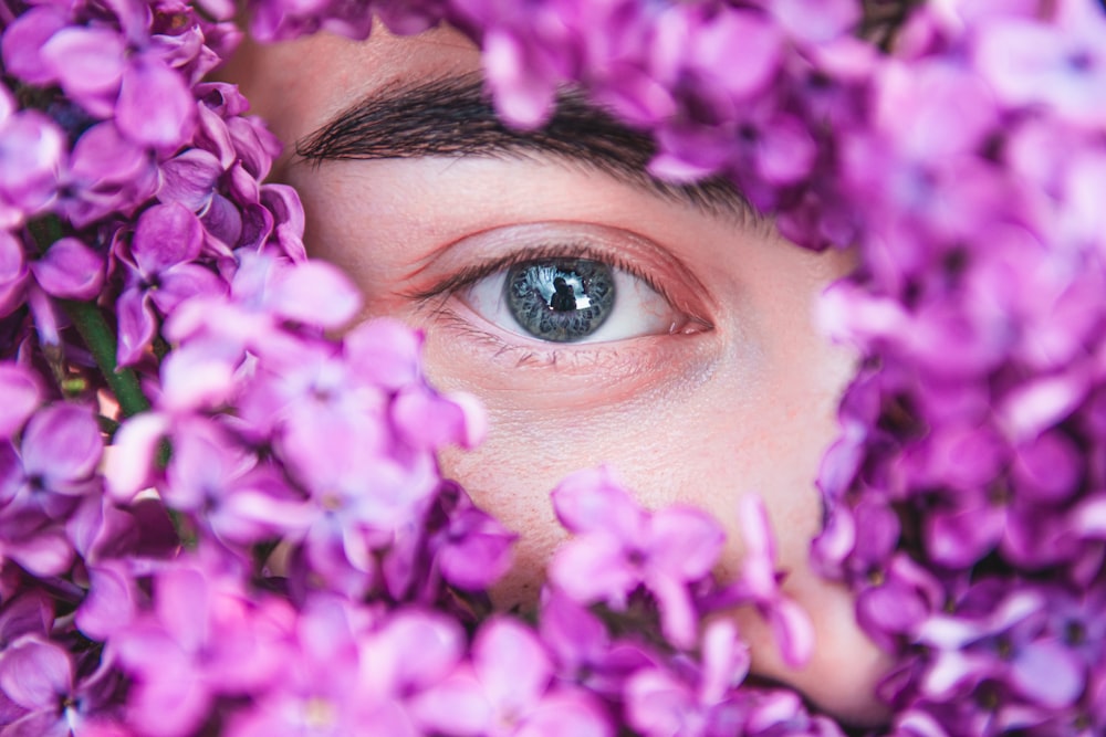 woman with purple flower on her face