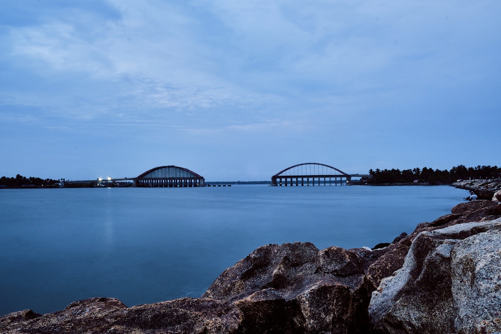 bridge over the water under cloudy sky