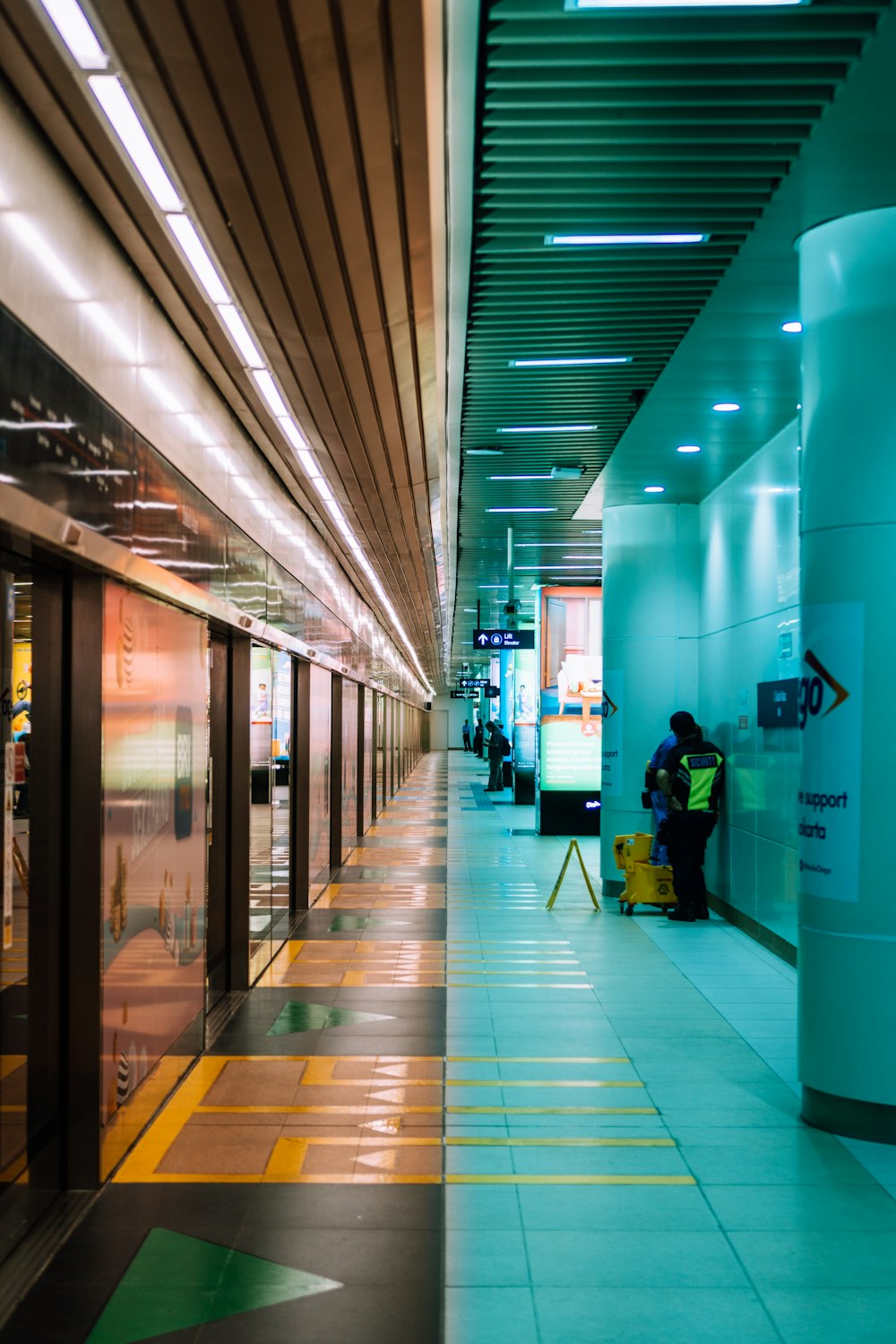 man in black jacket and black pants walking on hallway