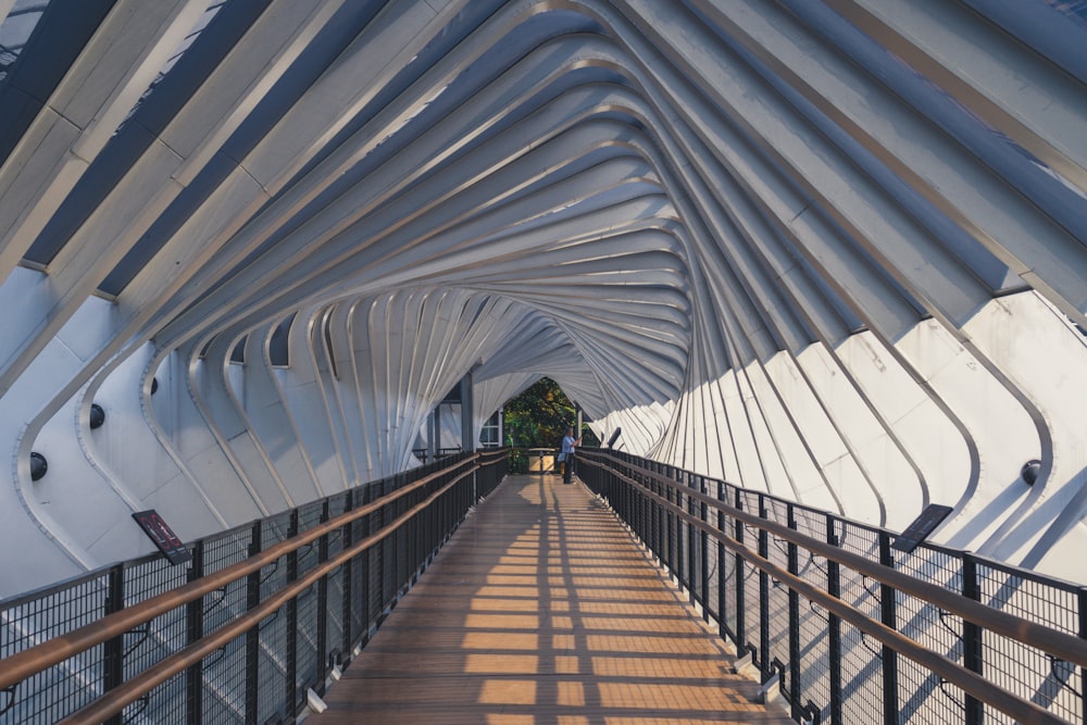 people walking on brown wooden bridge during daytime