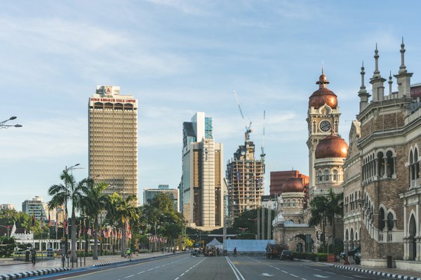 Brown and white concrete building near green trees during daytime — Kuala Lumpur, Malaysia
