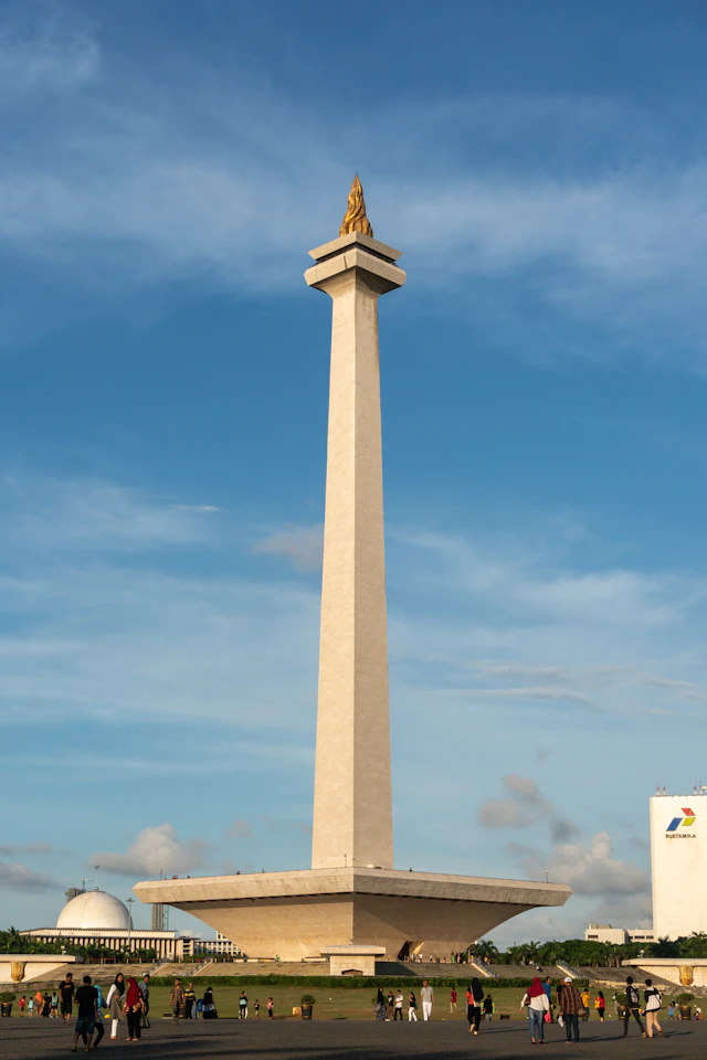Jakarta’s Monas National Monument with its golden flame and broad pedestal beneath a blue sky