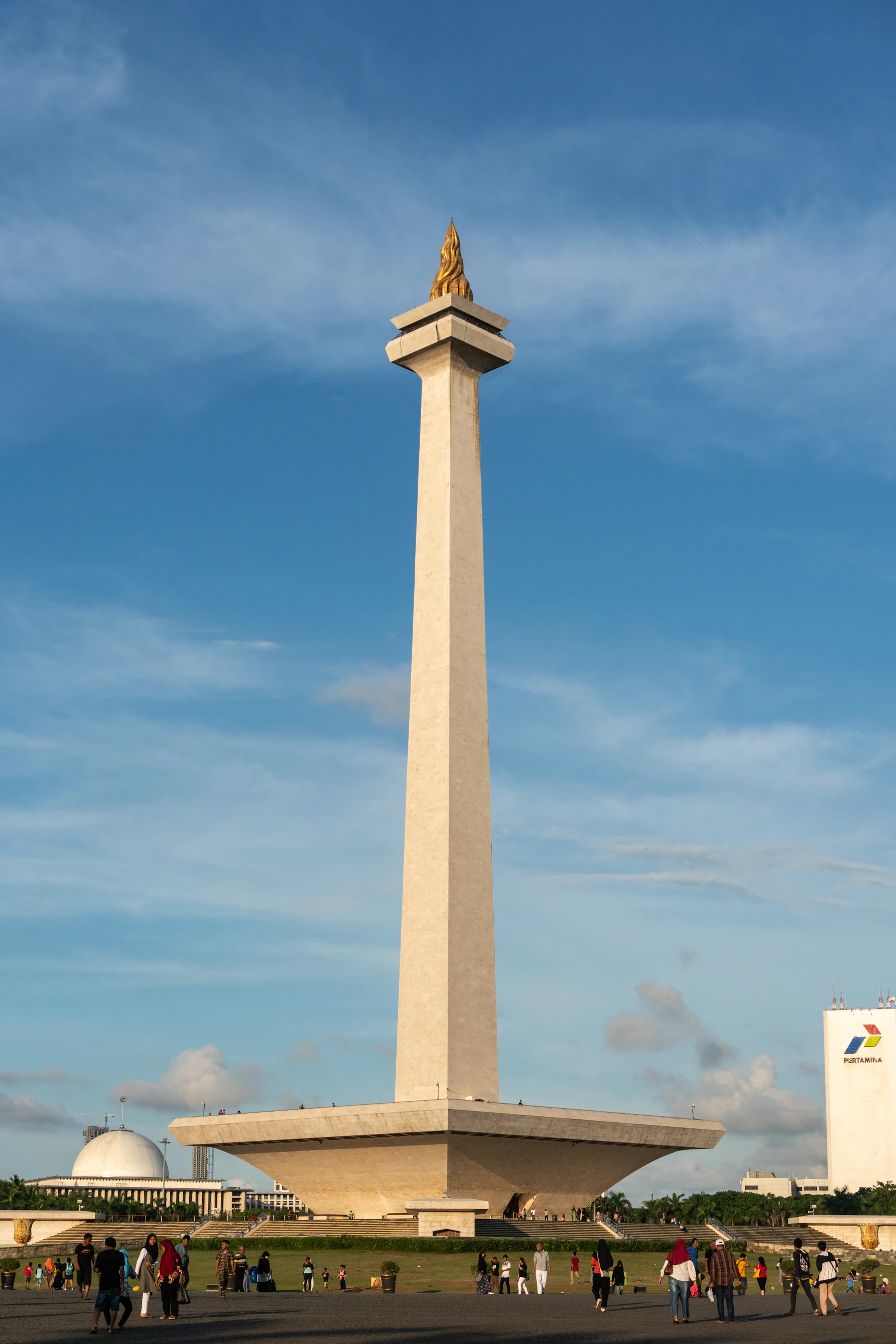 Jakarta’s Monas National Monument with its golden flame and broad pedestal beneath a blue sky