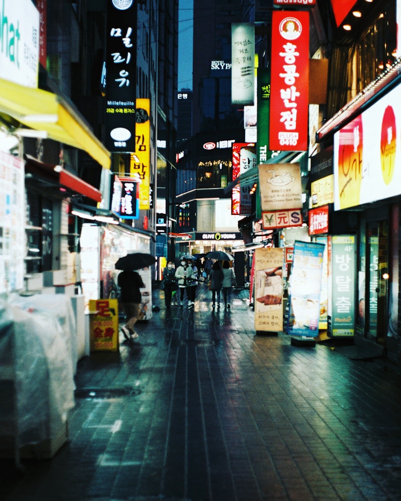 People walking a Seoul street at night