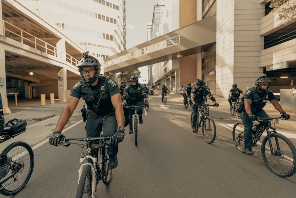 people riding bicycles on road during daytime