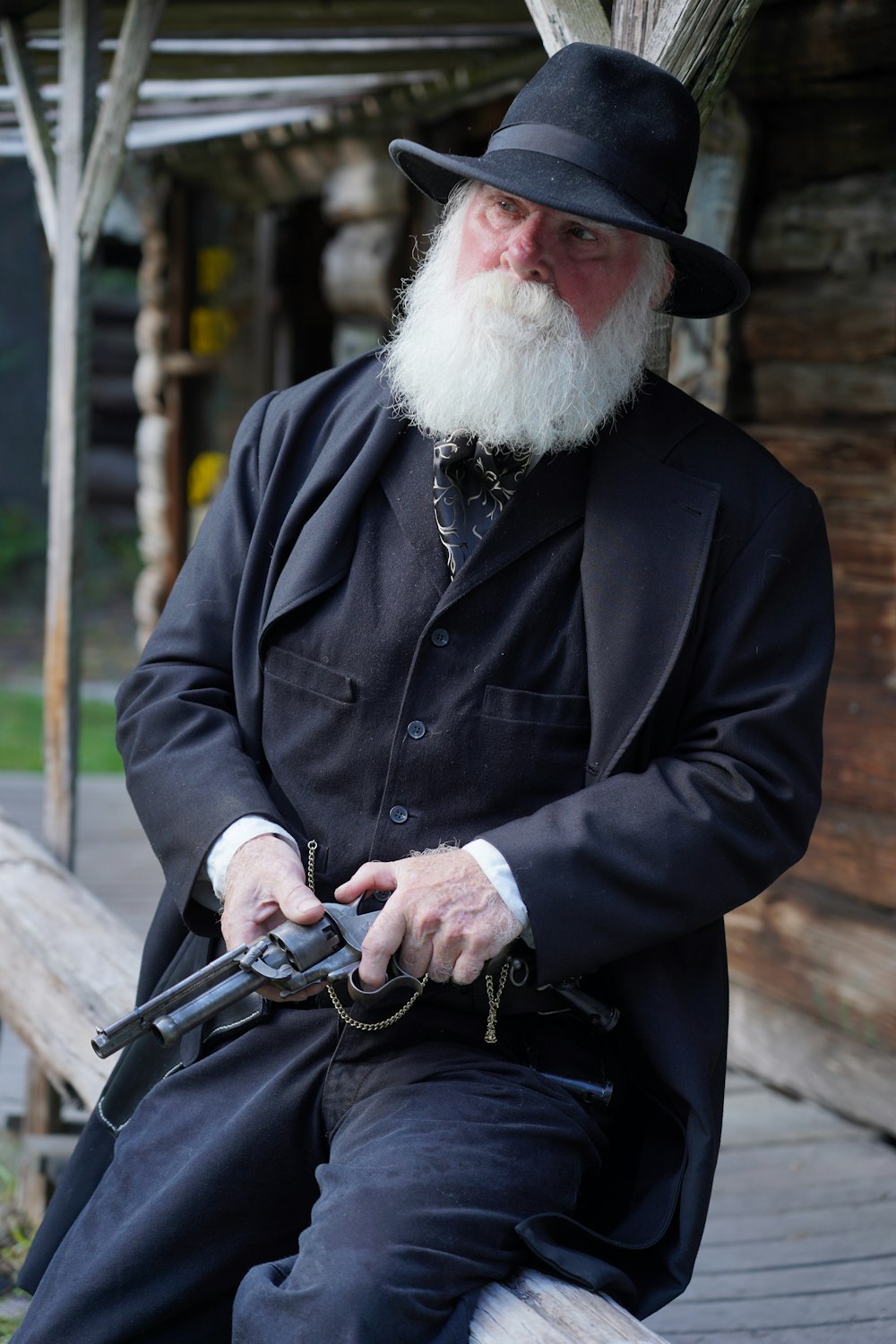 man in black coat holding black dslr camera