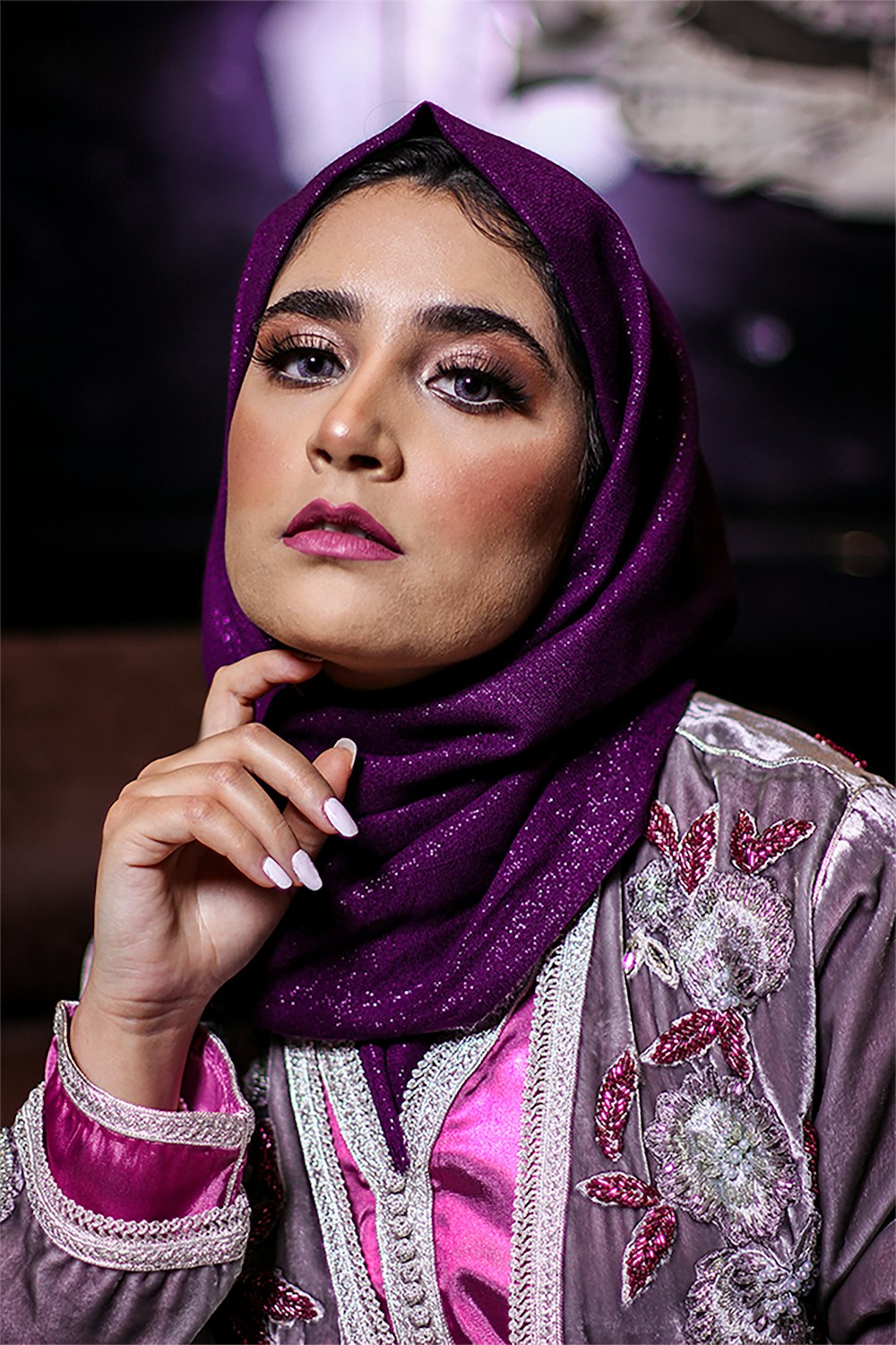 woman in purple hijab and white and red floral dress