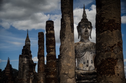 The majestic cliffs and ancient Buddha statues of Bamyan Valley under a clear blue sky.