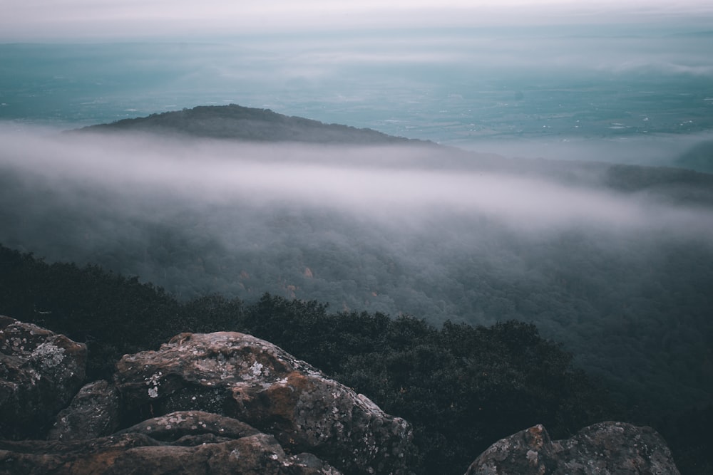 green and black mountain under white clouds during daytime