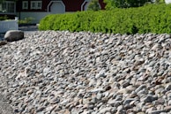 A rocky slope with carefully arranged stonework and native plants.