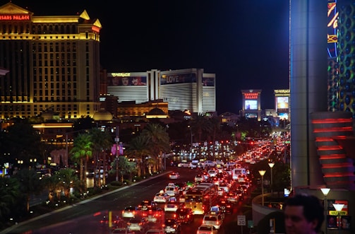Nighttime cityscape of Venus District with glowing signs and bustling streets.