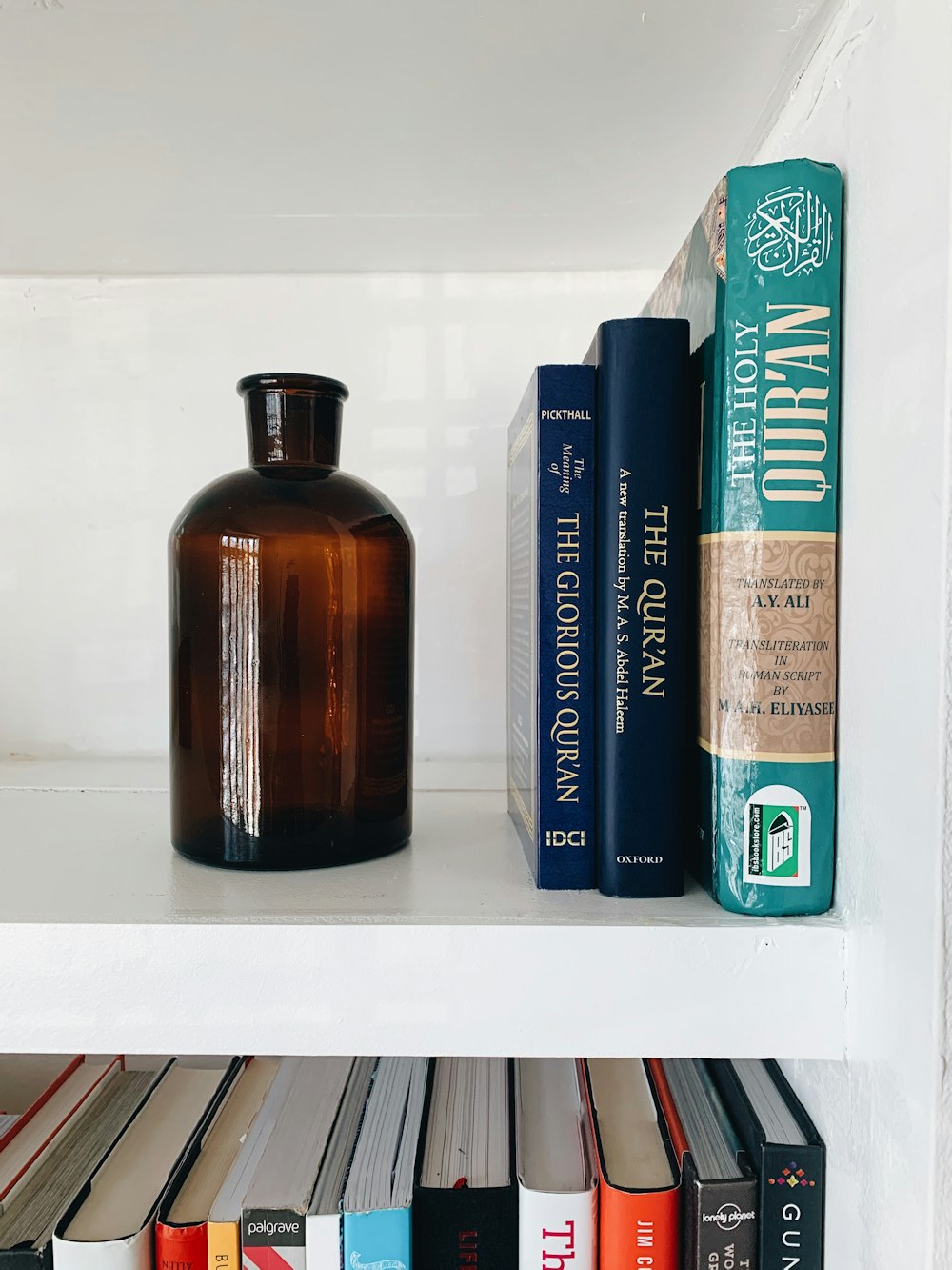 brown glass bottle on white shelf