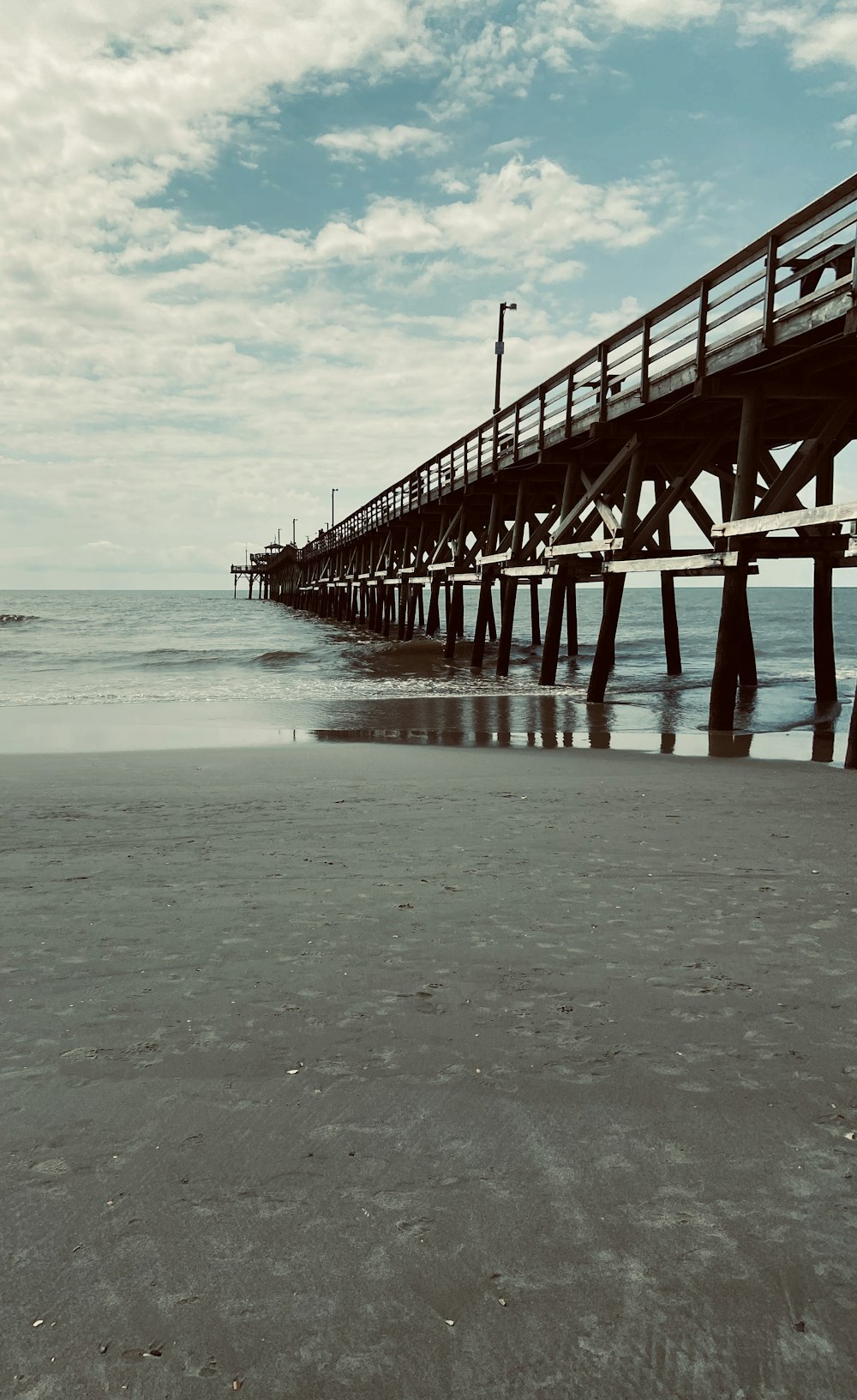 red wooden dock on sea during daytime