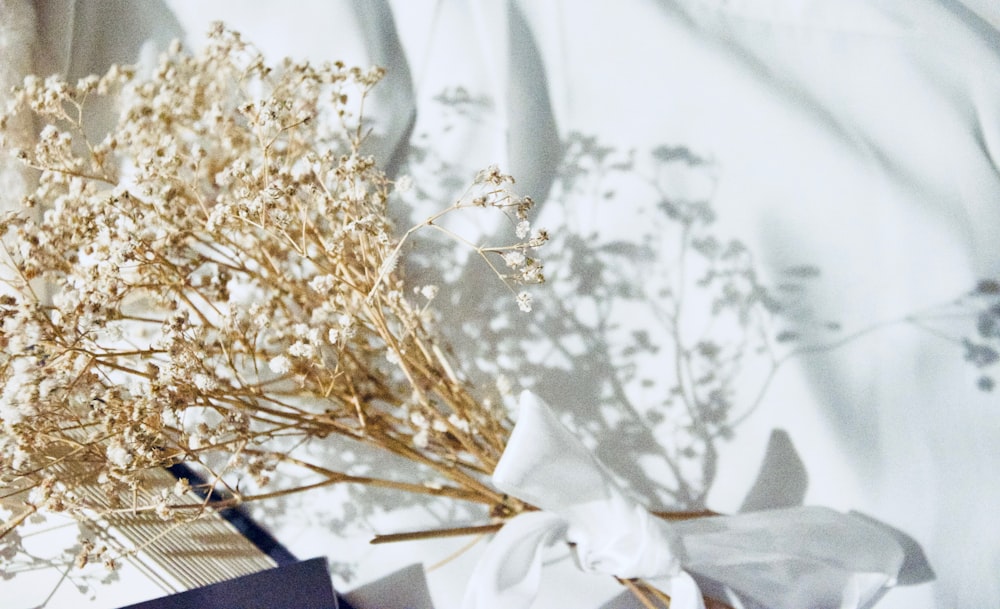 white flowers on white textile