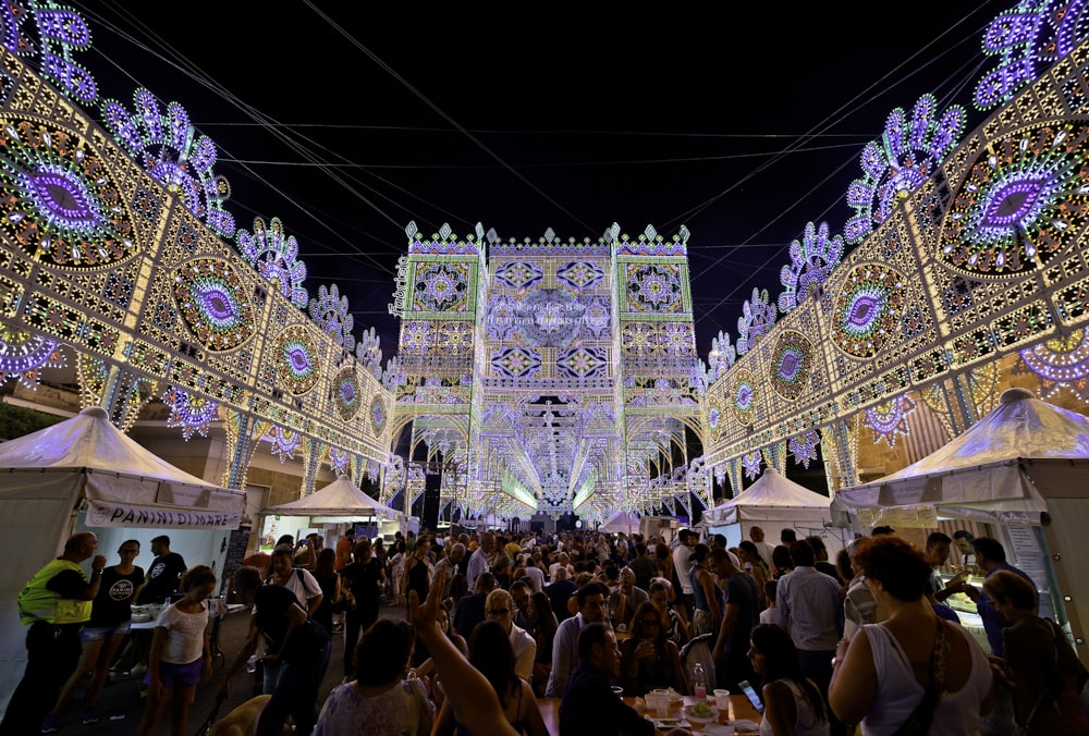 people gathering in a festival during night time