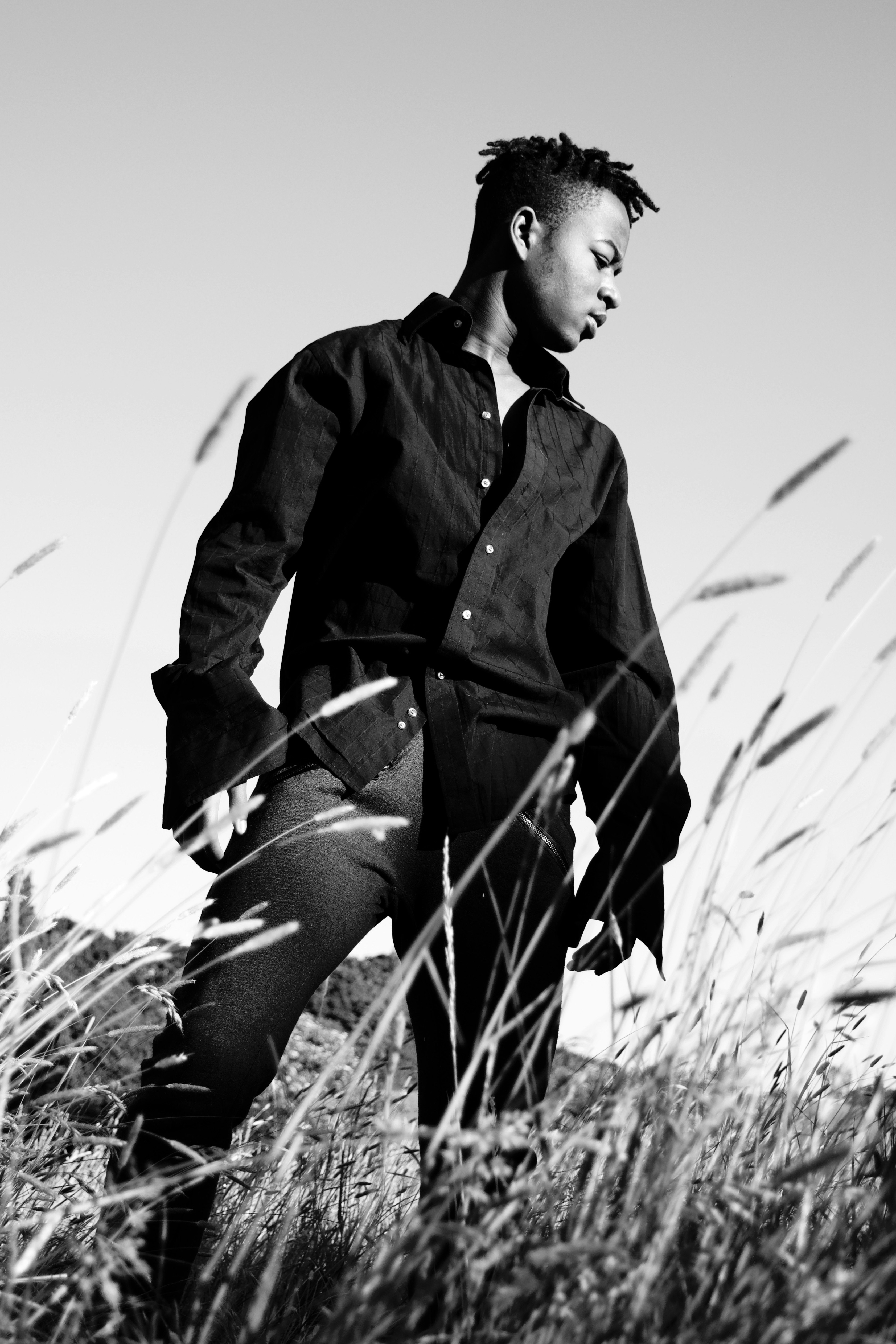 woman in black coat sitting on grass