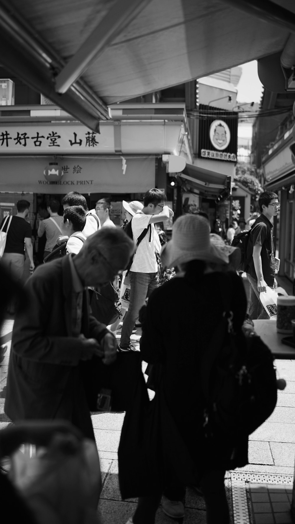 man in black jacket standing beside man in white dress shirt