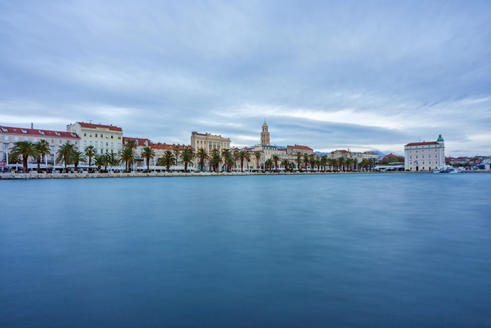 city skyline across body of water during daytime