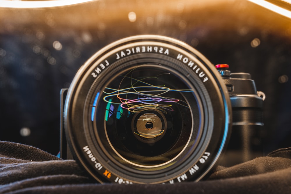 black nikon camera lens on brown wooden table