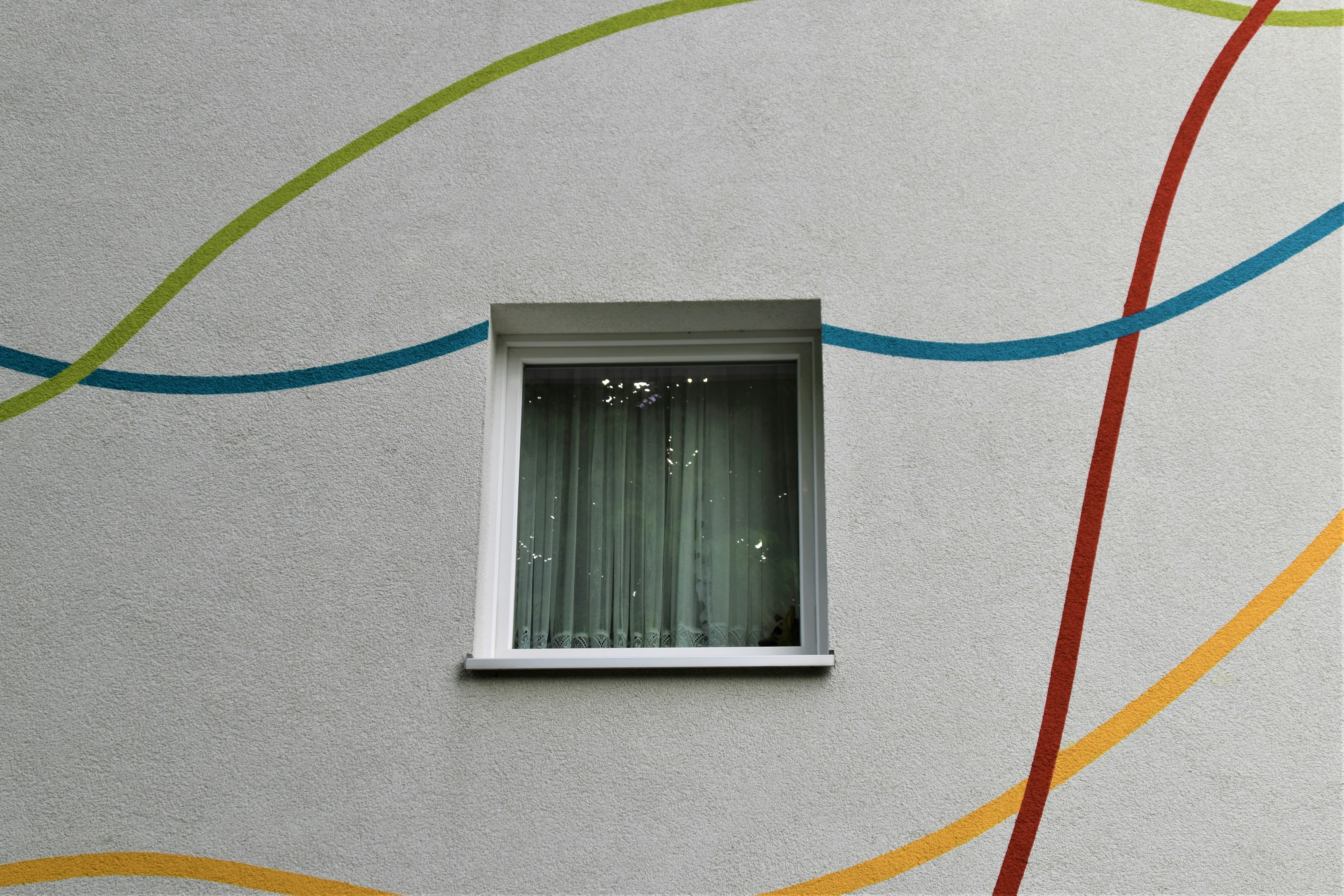Painted Cement Wall , window of a apartment building