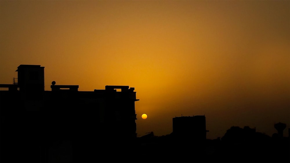 silhouette of building during sunset