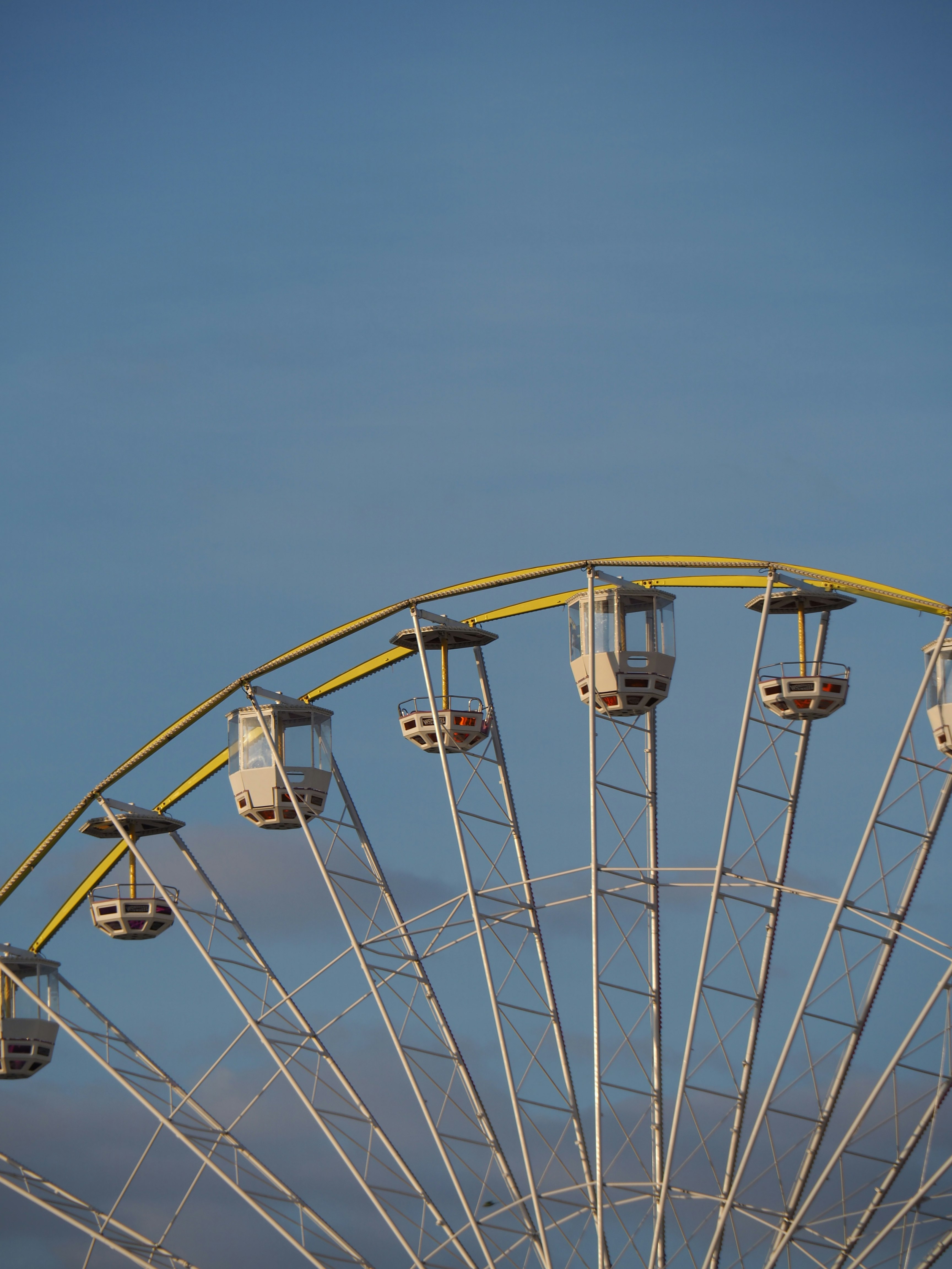 white ferris wheel under blue sky during daytime