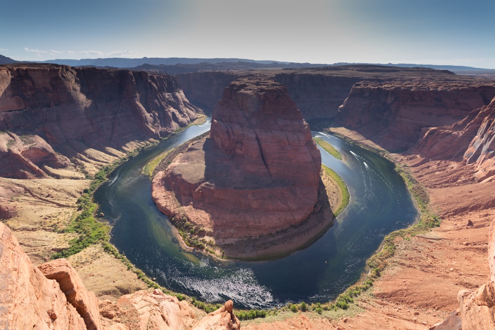 brown rock formation near river during daytime