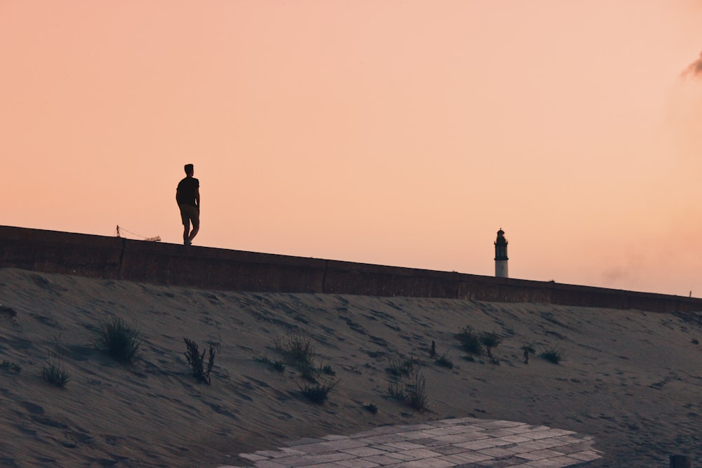 2 person walking on gray sand during daytime