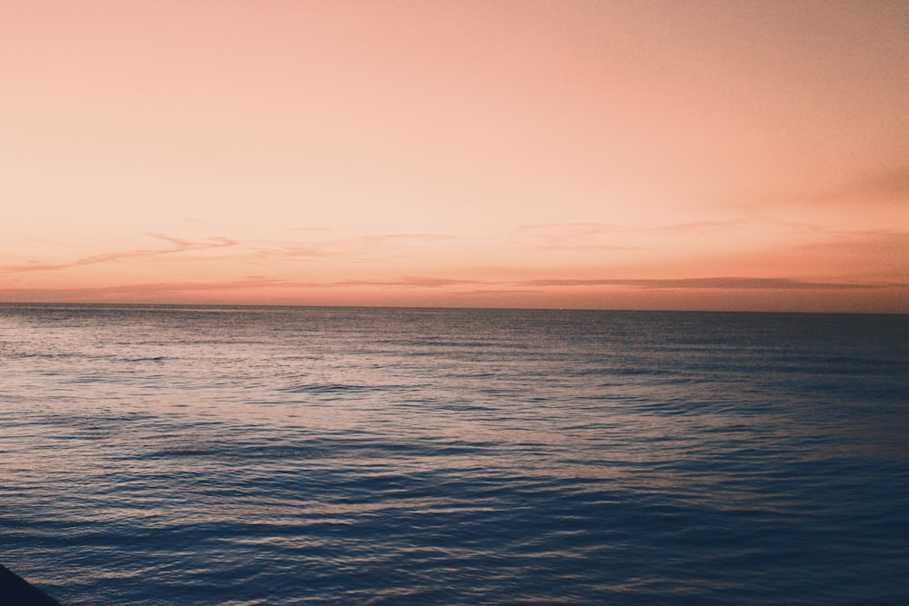 body of water during sunset