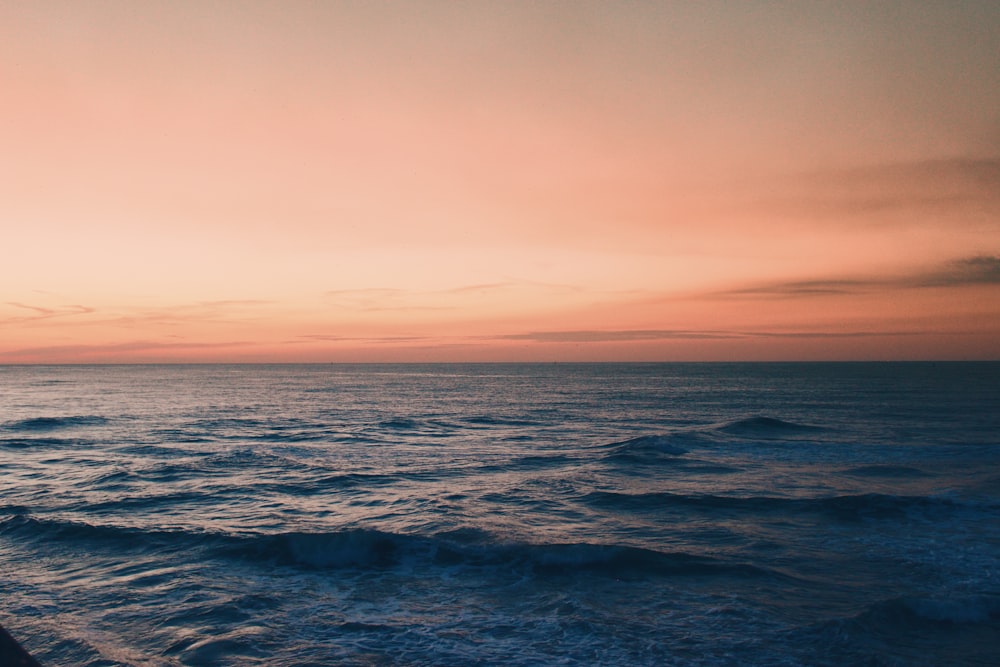 ocean waves under blue sky during daytime